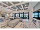 Bright living room with coffered ceiling, large sectional sofa, and fireplace at 9152 Warm Springs Cir, Parrish, FL 34219