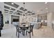 Open living space with coffered ceiling, gray sectional sofa and dining area at 9152 Warm Springs Cir, Parrish, FL 34219