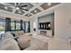 Relaxing living room with coffered ceiling, fireplace and large TV at 9152 Warm Springs Cir, Parrish, FL 34219