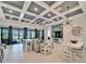 Spacious living room with coffered ceiling, sectional sofa and sliding doors at 9152 Warm Springs Cir, Parrish, FL 34219
