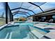 Relaxing pool and spa with screened enclosure and blue tile at 9152 Warm Springs Cir, Parrish, FL 34219