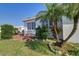 Landscaped backyard with a patio, palm tree, and lush greenery at 9156 142Nd St, Seminole, FL 33776