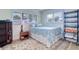Cozy bedroom with a full-size bed, window shutters, and a decorative rug at 9156 142Nd St, Seminole, FL 33776