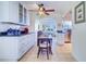 White kitchen with granite counters, glass-front cabinets, and breakfast nook at 9156 142Nd St, Seminole, FL 33776