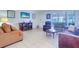 Living room with tiled floors, leather furniture, and a fireplace at 9156 142Nd St, Seminole, FL 33776
