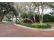 Brick entrance to the Stonebridge community with landscaping and flag at 9341 Wellington Park Cir, Tampa, FL 33647