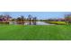 Spacious backyard with a pond view and lush green grass at 10827 High Noon Trl, Parrish, FL 34219