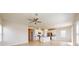 Open kitchen with white cabinets, granite countertops, and stainless steel appliances at 10827 High Noon Trl, Parrish, FL 34219