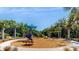 playground with swings, slides, and shaded seating at 10827 High Noon Trl, Parrish, FL 34219