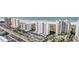 Aerial view of beachfront high-rise building with parking and ocean views at 1230 Gulf Blvd # 604, Clearwater Beach, FL 33767