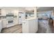 Bright kitchen features white cabinetry, modern appliances, and tile flooring at 1230 Gulf Blvd # 604, Clearwater Beach, FL 33767