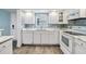 Modern white kitchen with quartz countertops at 1230 Gulf Blvd # 604, Clearwater Beach, FL 33767