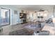 Living room features a comfy sofa, large TV, and access to balcony at 1230 Gulf Blvd # 604, Clearwater Beach, FL 33767