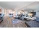 Open living area with gray sofa, wood-look floors, and ocean view at 1230 Gulf Blvd # 604, Clearwater Beach, FL 33767