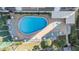 Overhead view of kidney-shaped pool and spa with surrounding lounge chairs at 1230 Gulf Blvd # 604, Clearwater Beach, FL 33767