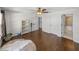 Light-filled bedroom with wood floors and access to bathroom at 12527 Pompanic St, San Antonio, FL 33576