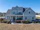 Two-story house with gray siding, white trim, and a covered porch at 12527 Pompanic St, San Antonio, FL 33576