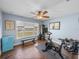 Home gym with Peloton bike, weights, and large window at 12527 Pompanic St, San Antonio, FL 33576