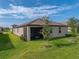 Landscaped backyard with a view of the house and surrounding area at 12626 Tahitian Pearl Cir, Parrish, FL 34219