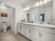 Bright bathroom boasts double sinks, vanity, and separate toilet area at 12626 Tahitian Pearl Cir, Parrish, FL 34219