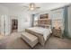 Spacious main bedroom with king-size bed, bench, and walk-in closet at 12626 Tahitian Pearl Cir, Parrish, FL 34219
