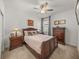 Comfortable bedroom with a wooden bed frame, nightstands, and ample closet space at 12626 Tahitian Pearl Cir, Parrish, FL 34219