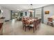 Elegant dining room with a large table, chandelier, and access to living room at 12626 Tahitian Pearl Cir, Parrish, FL 34219