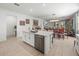 Open concept kitchen with island, stainless steel appliances, and views into dining area at 12626 Tahitian Pearl Cir, Parrish, FL 34219