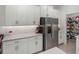 Well-equipped kitchen showcasing white cabinets, stainless steel appliances, and a pantry at 12626 Tahitian Pearl Cir, Parrish, FL 34219