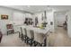 Modern kitchen featuring white cabinets, a large island, and stainless steel appliances at 12626 Tahitian Pearl Cir, Parrish, FL 34219