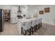 Spacious kitchen with white cabinets, an island with seating, and a large pantry at 12626 Tahitian Pearl Cir, Parrish, FL 34219