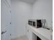 Small laundry room with microwave, cabinets, and countertop at 12626 Tahitian Pearl Cir, Parrish, FL 34219