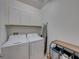 Convenient laundry room with washer, dryer, and overhead cabinets at 12626 Tahitian Pearl Cir, Parrish, FL 34219