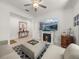 Open living area showcasing a sectional sofa, fireplace, and entryway view at 12626 Tahitian Pearl Cir, Parrish, FL 34219