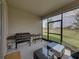 Relaxing screened patio with outdoor grill and seating area at 12626 Tahitian Pearl Cir, Parrish, FL 34219