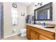 Bathroom with granite countertop, wood cabinets and shower at 12801 Big Sur Dr, Tampa, FL 33625