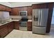 Stylish kitchen featuring stainless steel appliances, granite countertops, and beautiful wood cabinets at 12908 Brant Tree Dr, Riverview, FL 33579