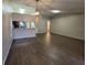 Spacious open-plan living room with hardwood floors, neutral walls, and sight lines to the kitchen at 12908 Brant Tree Dr, Riverview, FL 33579