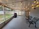 Relaxing screened patio with string lights and seating at 12908 Brant Tree Dr, Riverview, FL 33579