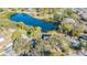 Aerial view of the house and surrounding area, near a lake at 131 Mystic Lake N Dr, St Petersburg, FL 33702