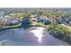 Aerial view showing a house near a lake, with surrounding trees and other houses visible at 131 Mystic Lake N Dr, St Petersburg, FL 33702