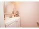 Powder room features vanity, a large framed mirror and light pink walls at 1330 70Th N St, St Petersburg, FL 33710
