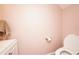 Bathroom features a toilet with a pink wall and visible paper towel holder at 1330 70Th N St, St Petersburg, FL 33710