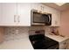 Modern kitchen boasts stainless steel appliances and stylish white cabinets with silver hardware at 1330 70Th N St, St Petersburg, FL 33710