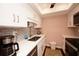 Bright kitchen featuring a stainless steel sink, white cabinets, and quartz countertops at 1330 70Th N St, St Petersburg, FL 33710