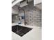 Close up of a modern kitchen sink with a stainless steel faucet and subway tile backsplash at 1330 70Th N St, St Petersburg, FL 33710