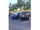 Two cars parked in a residential parking lot with palm trees in the background at 1330 70Th N St, St Petersburg, FL 33710