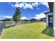 Spacious backyard with screened patio and lush lawn at 13307 Fawn Lily Dr, Riverview, FL 33579