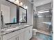 Bathroom with granite countertops, double sinks, and a walk-in shower at 13307 Fawn Lily Dr, Riverview, FL 33579