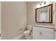 Chic powder room with granite countertop, white cabinets, and patterned floor tile at 13307 Fawn Lily Dr, Riverview, FL 33579